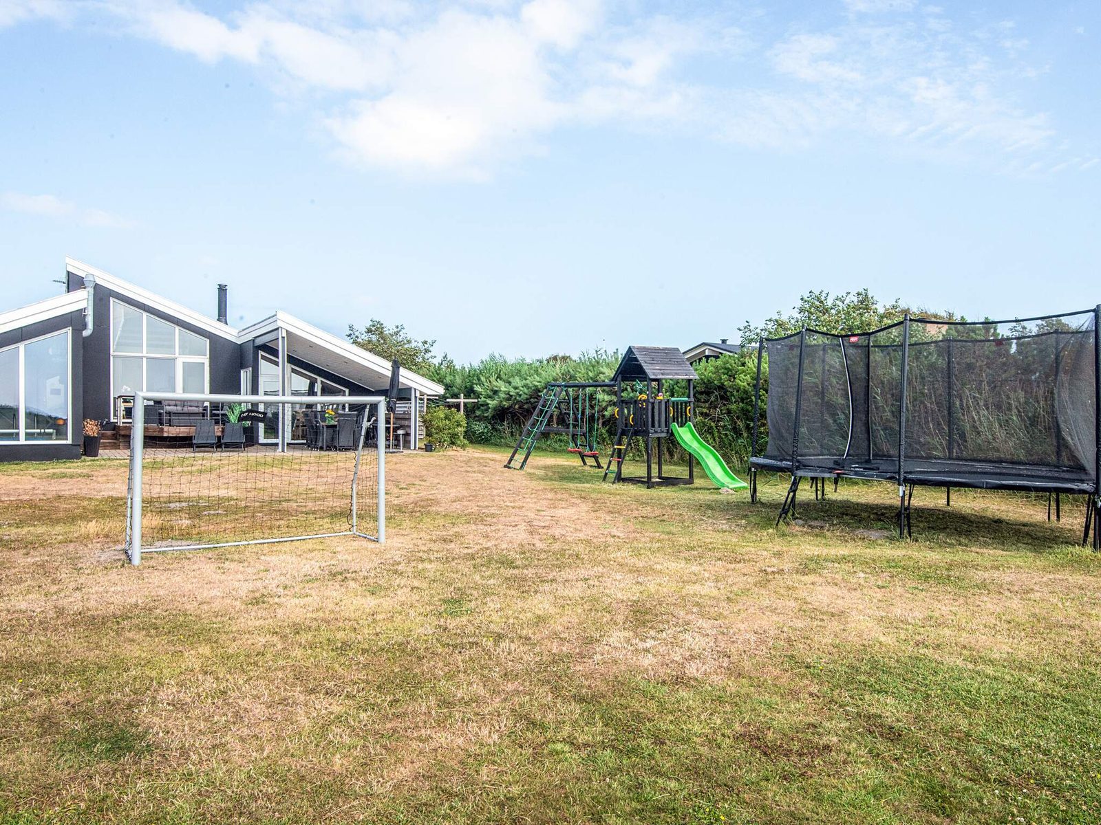 The garden looking back at the house, with trampoline and climbing frame