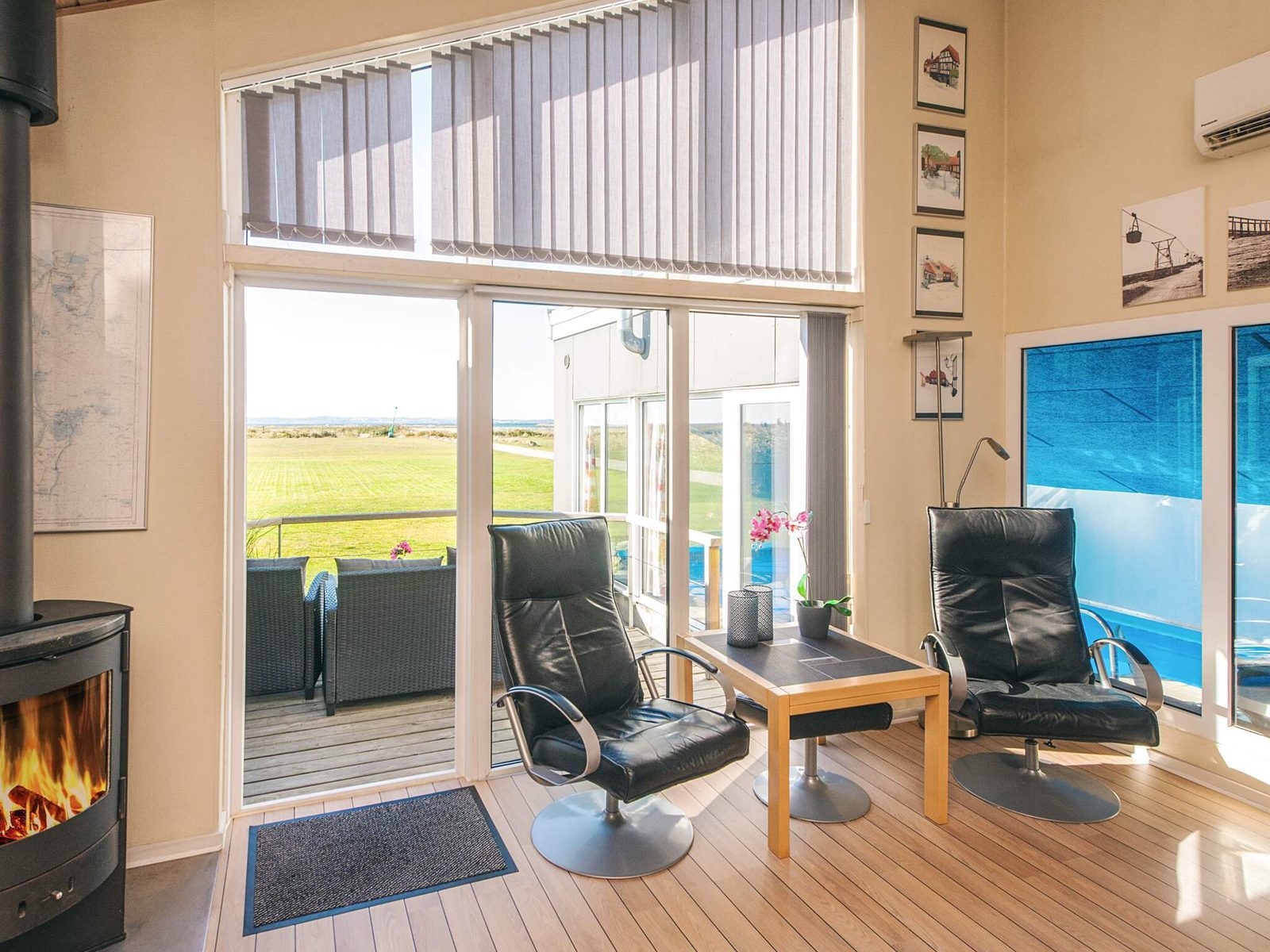 The wood-burning stove, with armchairs and a view of the garden