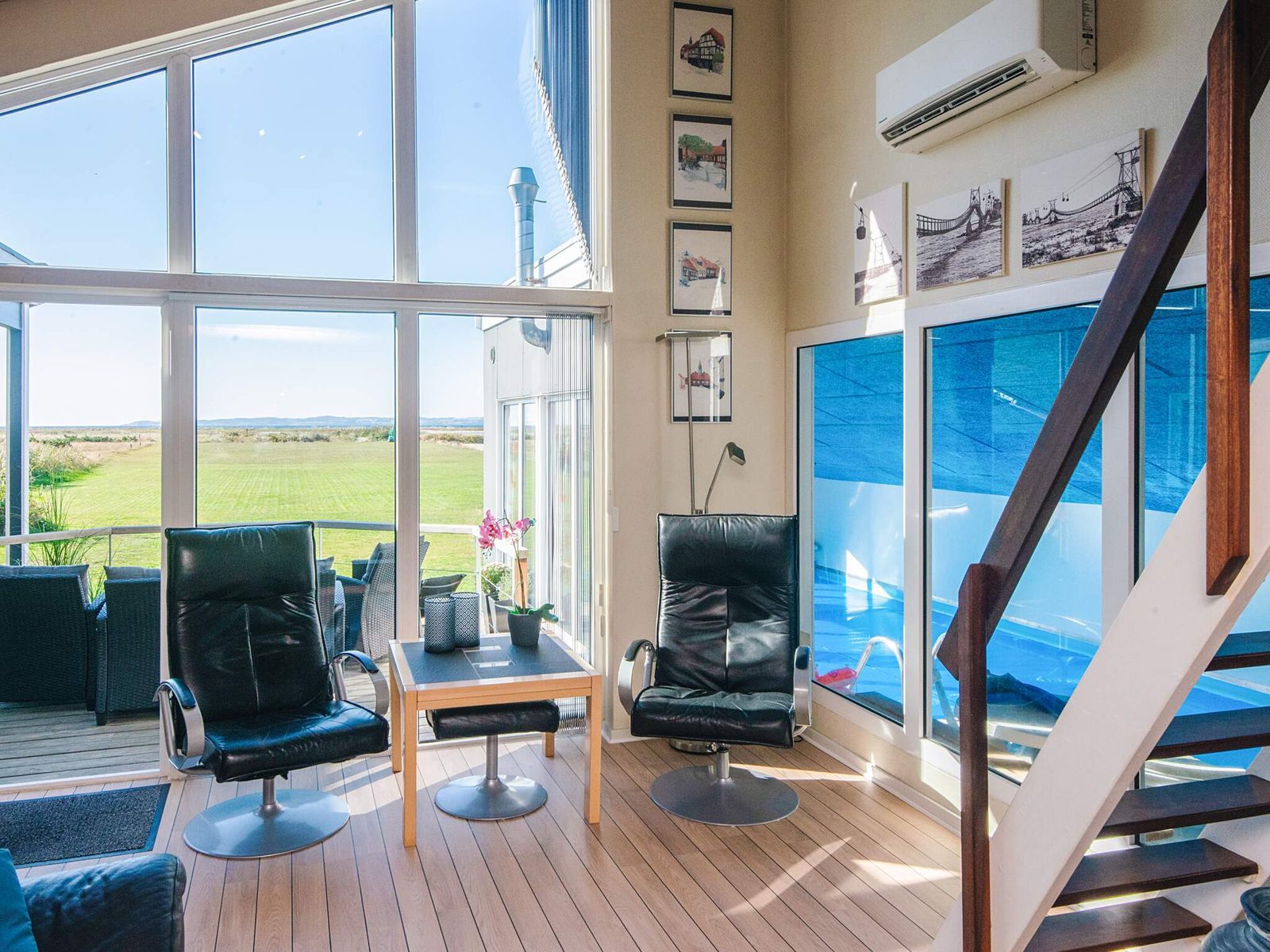 Seating at the window wall, looking over open land