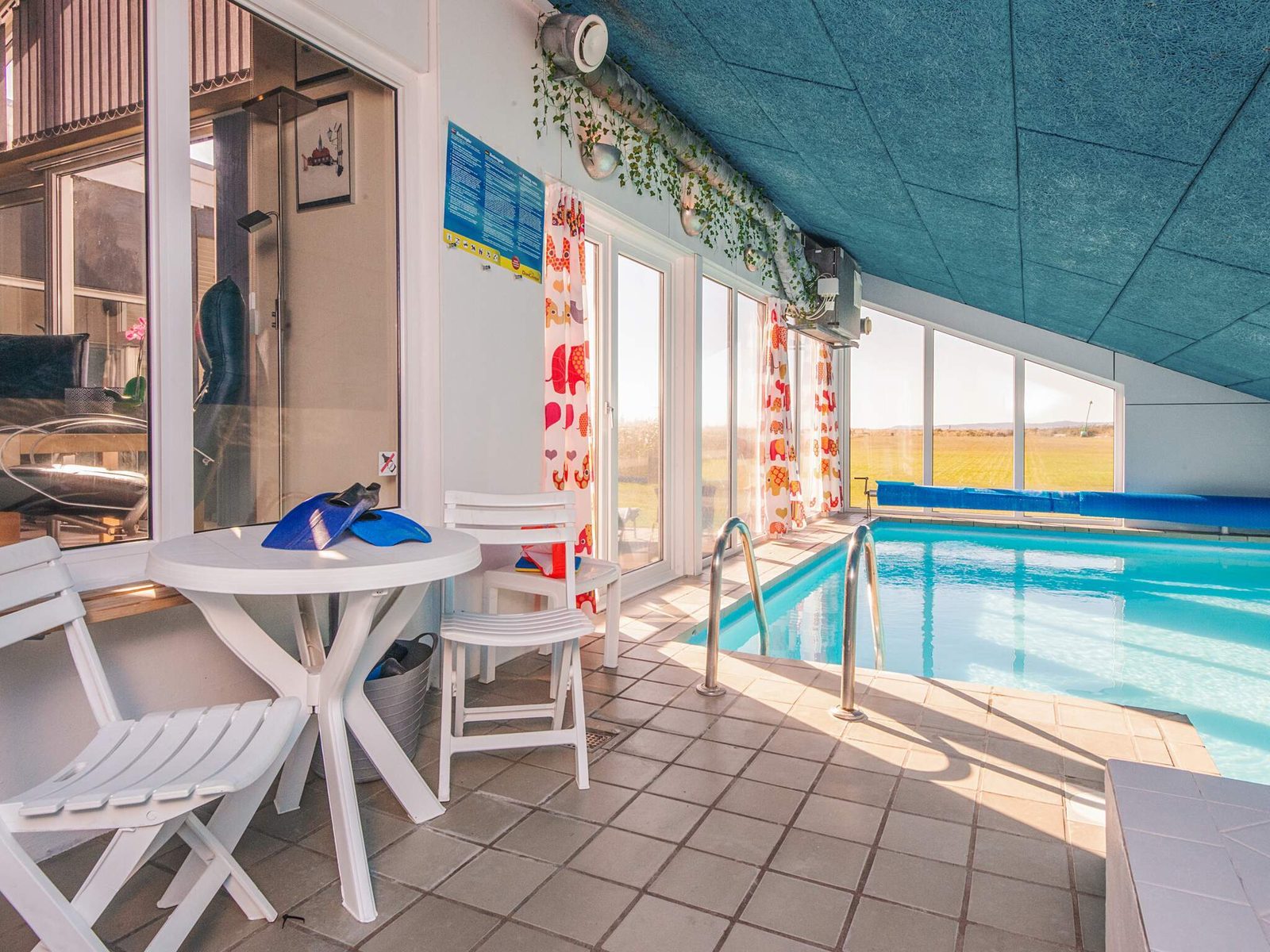 Seating beside the pool, glazed towards the garden