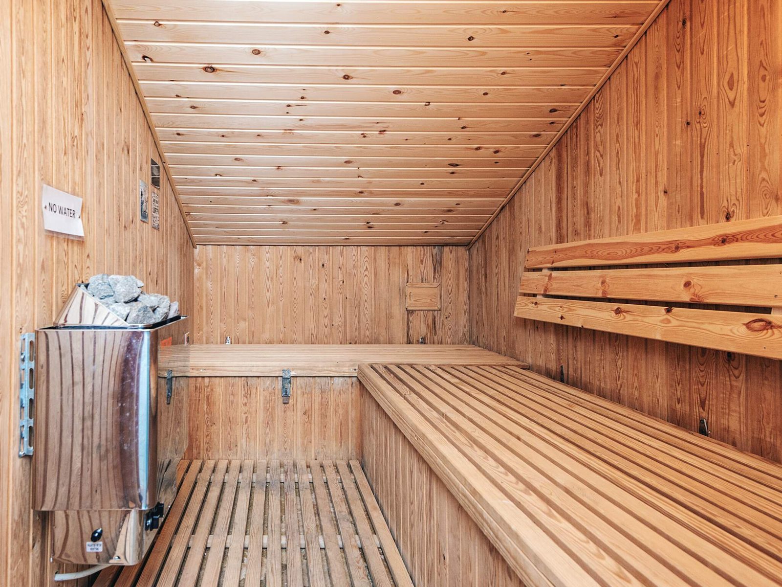 Finnish sauna with timber benches on two levels