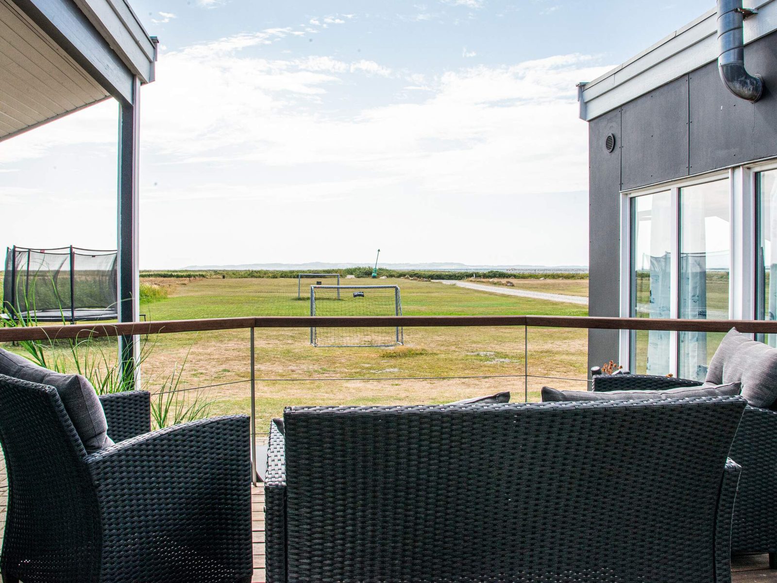 The view over open land and water from the covered terrace